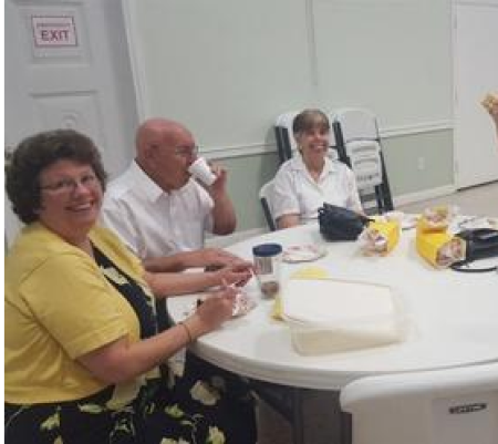 A group of people sitting at a table eating.