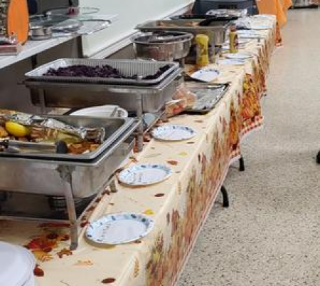 A long table with many plates and bowls on it